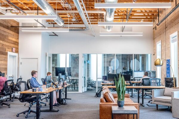 Image of an office with workers sitting at their desks.
