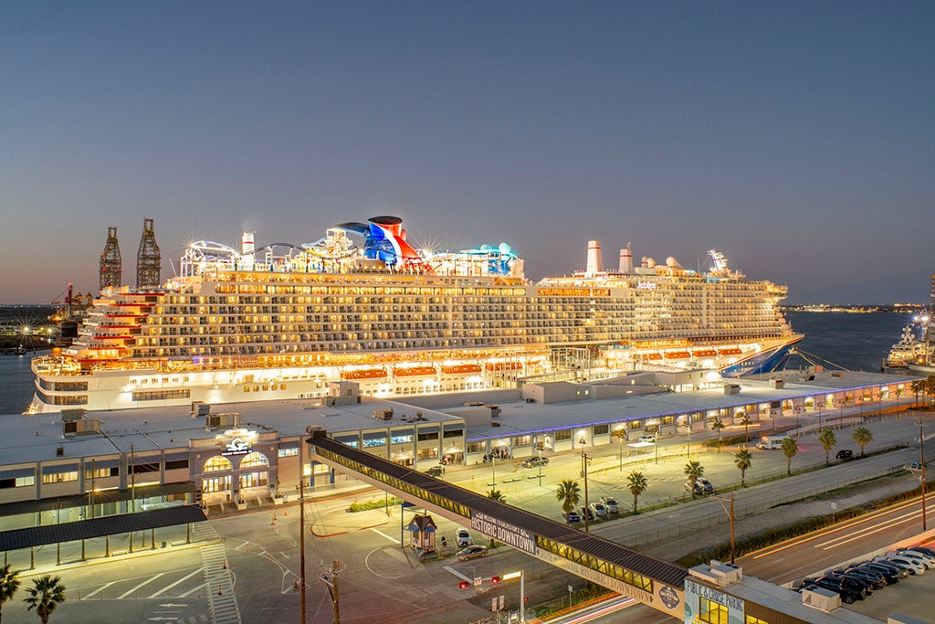 Aerial of Cruise Terminal 25 with Carnival Jubilee docked at night