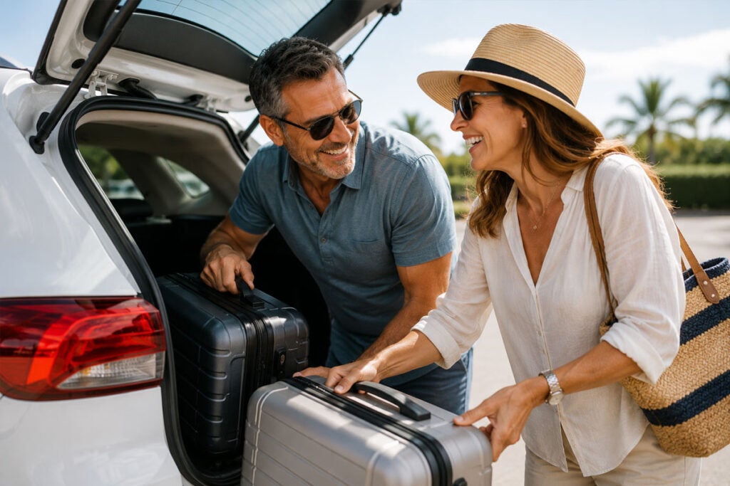 Happy couple unloading luggage before their cruise out of Galveston