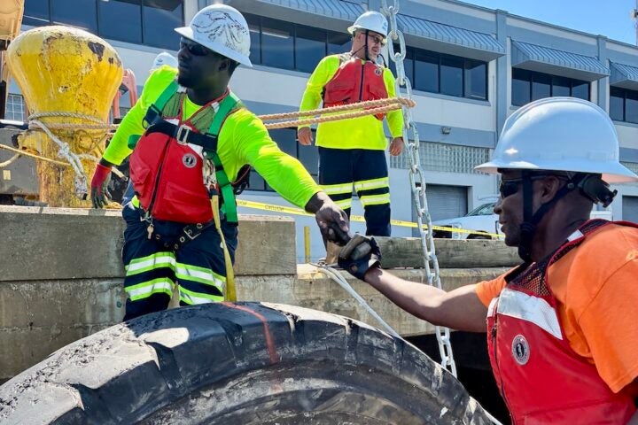 The Construction and Maintenance (C&M) team installs a temporary tire fender at Cruise Terminal 25.